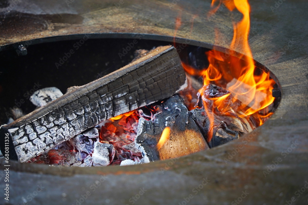 Burning logs in a cauldron in the open air
