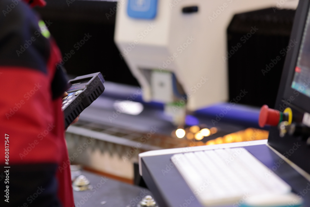 operator controlling CNC laser cutting machine operator controlling CNC laser cutting machine