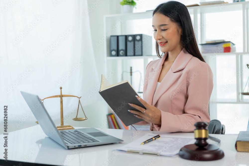 Legal genius female lawyer working with laptop in law office, judge hammer with justice, justice concept