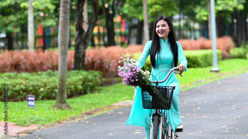 A young girl wearing a jade-green ao dai the traditional costume of Vietnam. Photo for tourism, culture, tradition, and the beauty of Asian people. Idea for train model in computer vision systems