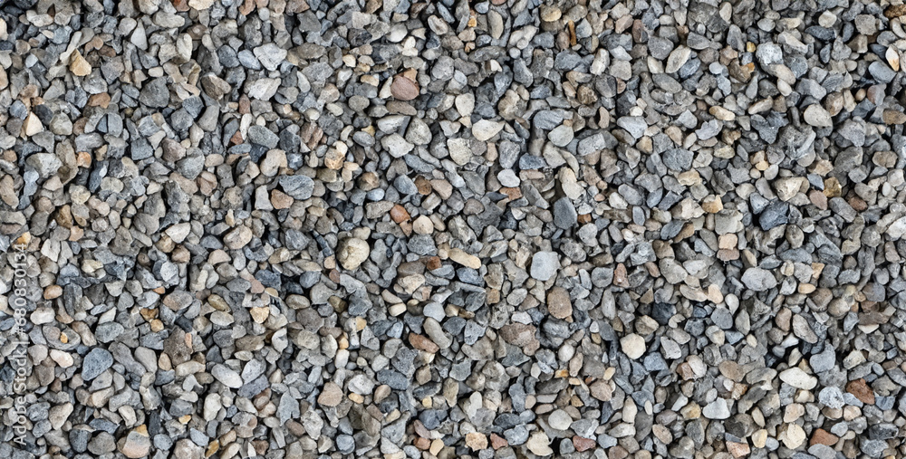 the gritty and uneven texture of walking barefoot on a gravel path, close up of a lot of black and white stones the gritty and uneven texture of walking barefoot on a gravel path, close up of a lot of black and white stones