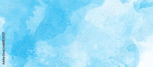 beautiful brush painted watercolor stains on blue background, Sky clouds with brush painted blue watercolor texture, small and large clouds alternating and moving slowly on cloudy winter morning sky.