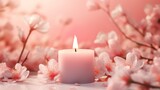Soft pink candle with white flowers on pink background