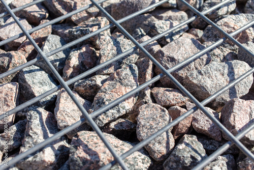 Stones under a metal grate. Background © schankz