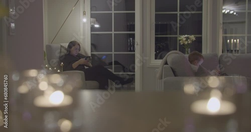 Mom and son at home on smartphone. Modern society, family relationships. Zoom out photo