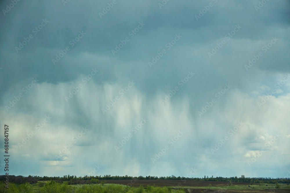 Landscape with the texture of clouds during a downpour. Rain, view from the side. The nature of the central part of Eurasia. Landscape with the texture of clouds during a downpour. Rain, view from the side. The nature of the central part of Eurasia.