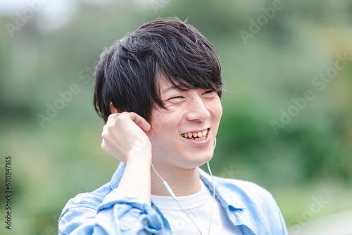 イヤホンで音楽を聴く男性　earphone	 photo