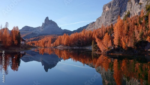 4k drone flight moving to the side footage (Ultra High Definition) of popular tourist destination - Federa lake among larch trees. Impressive sunrise in Dolomite Alps. Gorgeous morning scene of Italy.