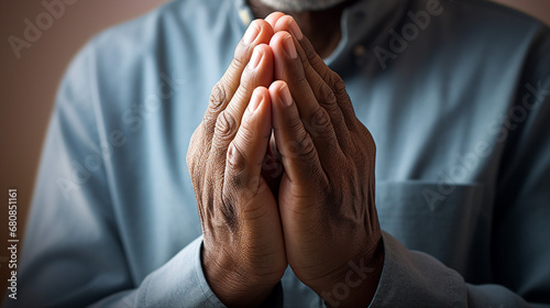 Closeup of senior man hands praying photo