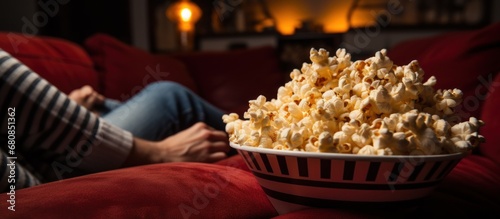 Popcorn snack while watching a movie on the couch at theater room. AI generated image photo
