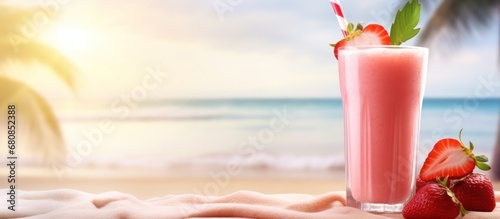 Fresh summer drink of strawberry juice on tropical beach background photo