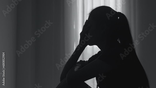 Silhouette of a woman with symptoms of depression and depression, Sadness, Anxiety, Family Problems, Mentally ill Person, Domestic Violence photo