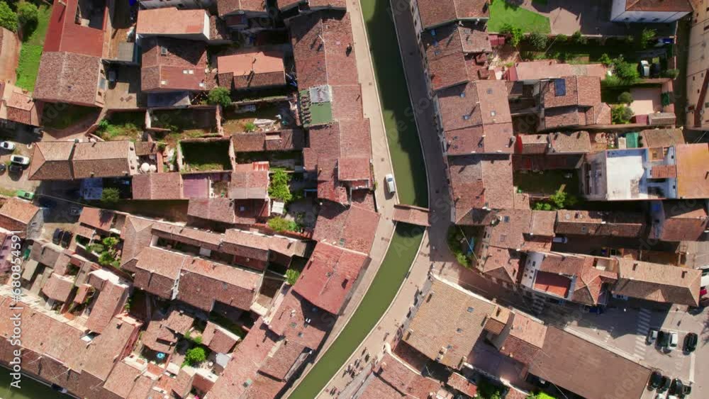 Comacchio, Italy, drone top down view of urban infrastructure, city's canal, little Italian city, sunny weather Comacchio, Italy, drone top down view of urban infrastructure, city's canal, little Italian city, sunny weather