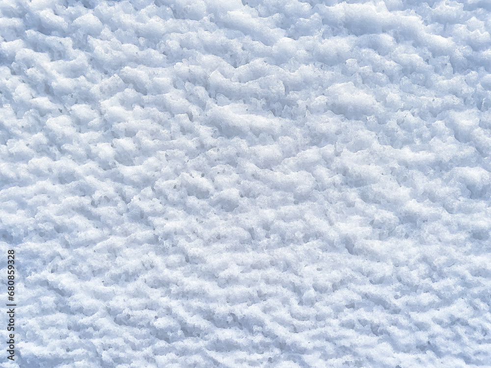 Fototapeta premium Winter background with snow patterns. Abstract background. The natural texture of snow. Icy surface. Clean, fresh snow. Ice pattern. Close-up. View from above. New Year's background. Copy space