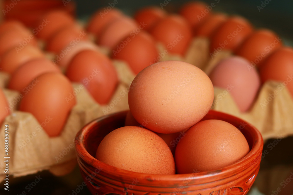 Eggs in a bowl with eggs background close-up