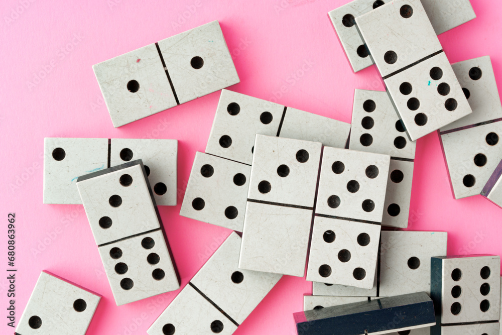 Domino tiles on pink background studio shot Domino tiles on pink background studio shot