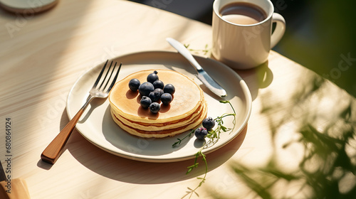 pancake blueberry black raspberry in white ceramic plate fork with space in sunlight photo