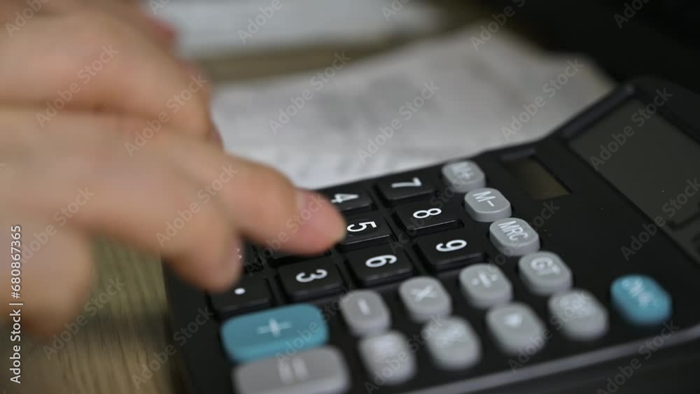 Man's hands using a calculator. Tax time.Tax concept. Close-up. Man's hands using a calculator. Tax time.Tax concept. Close-up.