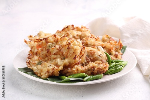 Bakwan sayur is Indonesian deep fried vegetable fritters. Found nation wide, mostly sold by street food vendors, the most popular version uses a mix of cabbage, carrot, and mung bean sprouts. photo