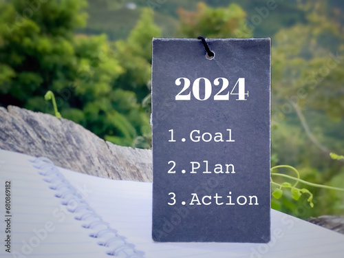 New Year Resolution Concept - 2024 goal plan action text with blurry nature background. Stock photo.