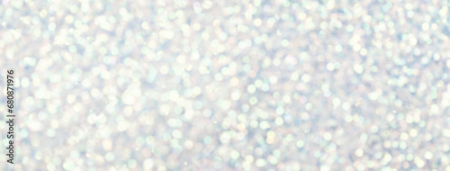 Blurred white background with circle sparkling lights. Shiny brilliant glittery bokeh of christmas garland.