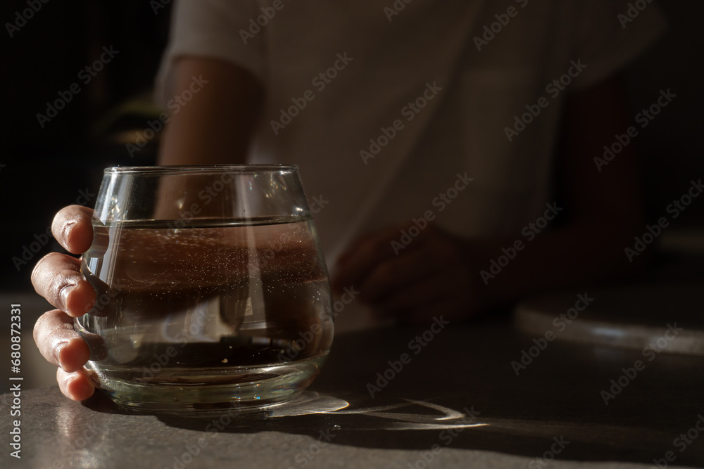 A glass of clean water in a child's hand