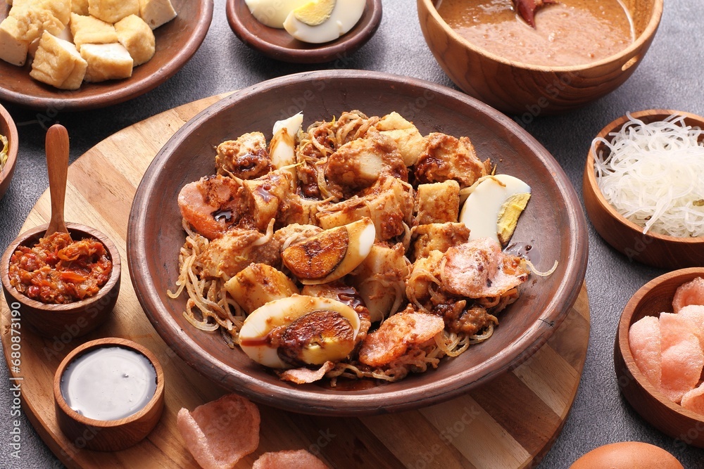 Ketoprak is a traditional Indonesian street food dish. It is a vegetarian dish from Jakarta, consisting of tofu, vegetables, rice cake, and rice vermicelli served in peanut sauce. Ketoprak is a traditional Indonesian street food dish. It is a vegetarian dish from Jakarta, consisting of tofu, vegetables, rice cake, and rice vermicelli served in peanut sauce.