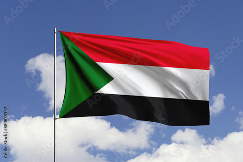 Sudan flag fluttering in the wind on sky.