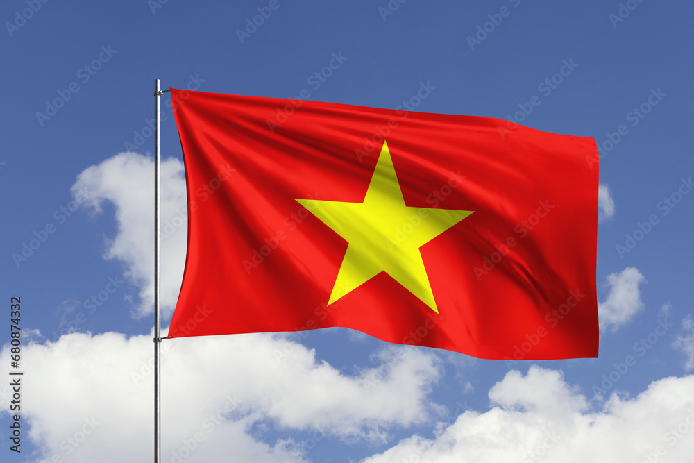 Naklejka premium Vietnam flag fluttering in the wind on sky.