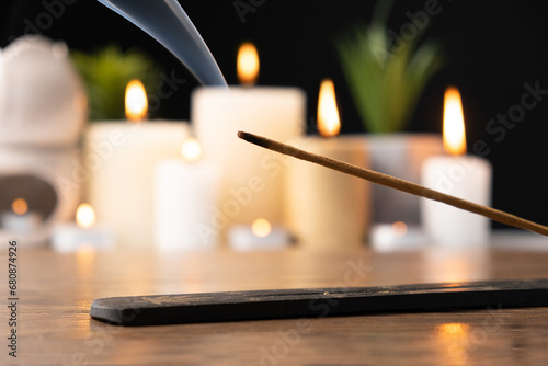 Incense stick on black and wooden background, incense smoke, for meditation and aromatherapy. photo