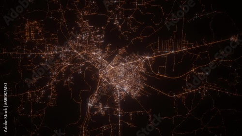 Alexandria (Louisiana, USA) top view at night. View on modern city from satellite. Camera is zooming in, rotating counterclockwise. Vertical video. The north is on the left side photo