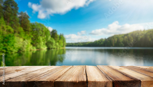 Empty wooden table top with blur background of summer lakes. For product showing © Giuseppe Cammino