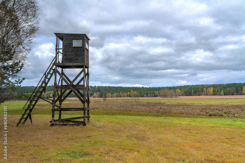 Landscape with hunting lodge in middle of meadow