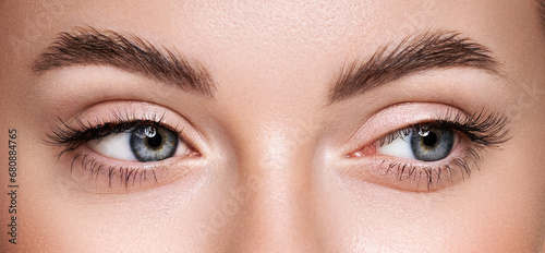Beautiful female eyes with long eyelashes. Eyelash extensions. Makeup, cosmetics, beauty. Close up, macro photo