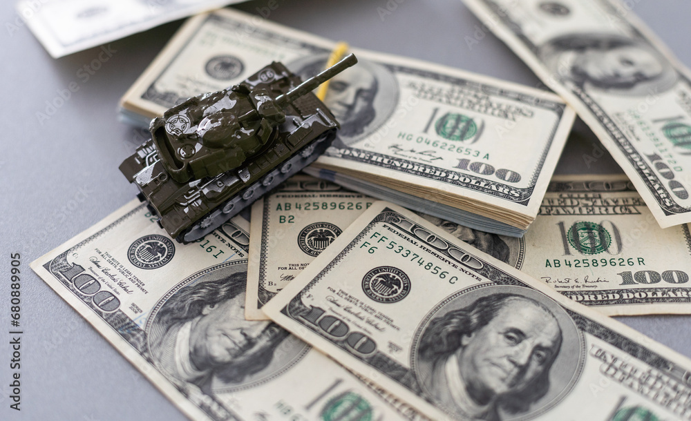 toy tank on the background of dollar bills toy tank on the background of dollar bills