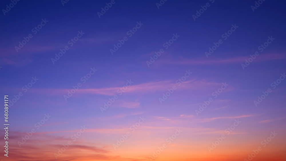 Colorful twilight sky background with beautiful sunlight and sunset cloud after sundown in evening time, idyllic peaceful nature background