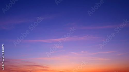 Colorful twilight sky background with beautiful sunlight and sunset cloud after sundown in evening time, idyllic peaceful nature background