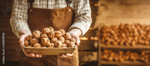 A pair of hands cradling fresh, brown, organic walnuts, showcasing their natural and healthy attributes in the midst of autumn. photo