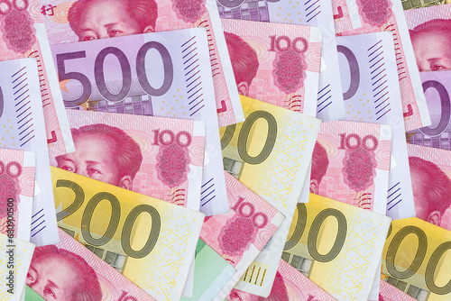 yuan and Euro banknotes on wooden background. photo