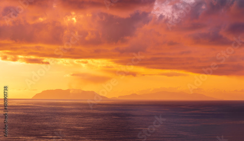 view at sunrise or sunset in sea with nice beach , surf , calm water and beautiful clouds on a background of a sea landscape