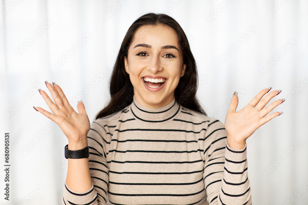 Glad excited young pretty middle eastern lady teacher, student with open mouth Glad excited young pretty middle eastern lady teacher, student with open mouth