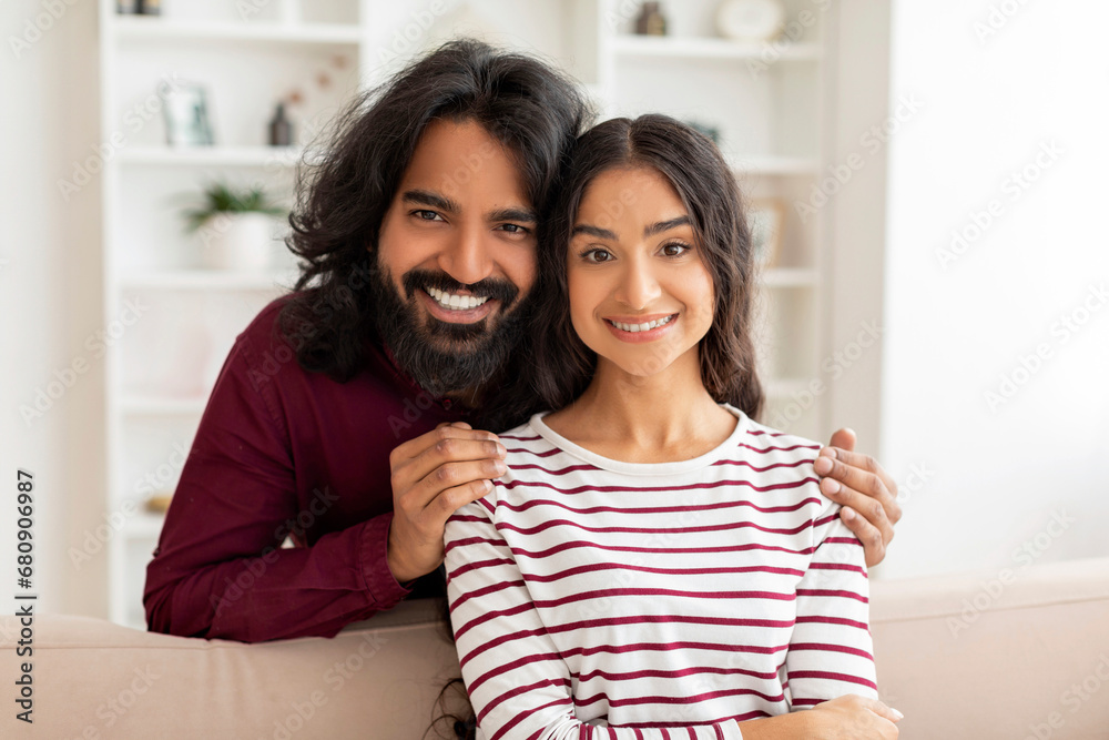 Portrait of loving indian couple posing at home