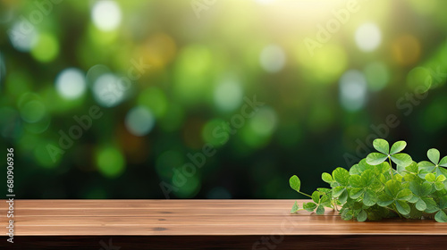 Empty wooden table over blurred clovers, shamrock leaves ,St. Patrick's Day,  mock up, display, product display 