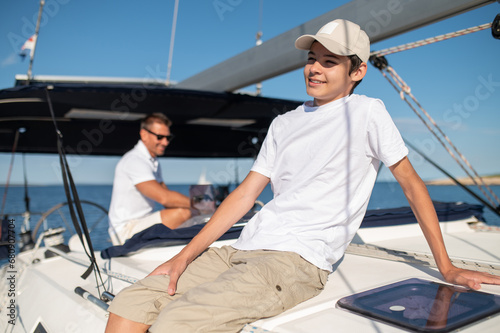 Dad and son on the yacht looking happy and cheerful © zinkevych