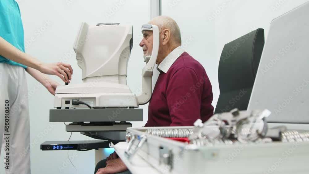 Grandfather undergoes vision diagnostics in a modern clinic. An expert checks vision using diagnostic ophthalmological equipment. Grandfather undergoes vision diagnostics in a modern clinic. An expert checks vision using diagnostic ophthalmological equipment.