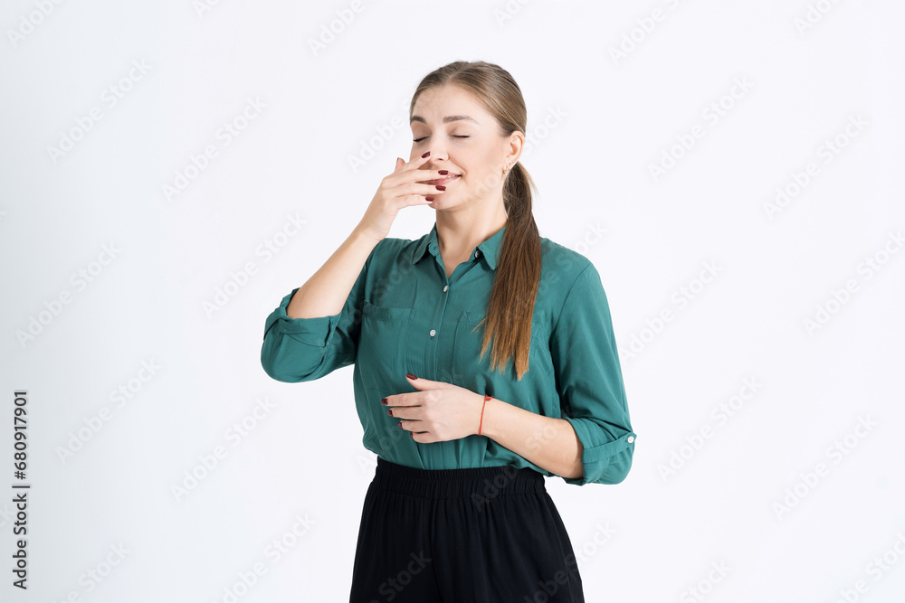 Attractive young woman with allergies sneezes. The girl feels bad because of a runny nose, isolated on a white studio background. The concept of allergy, flu and virus Attractive young woman with allergies sneezes. The girl feels bad because of a runny nose, isolated on a white studio background. The concept of allergy, flu and virus