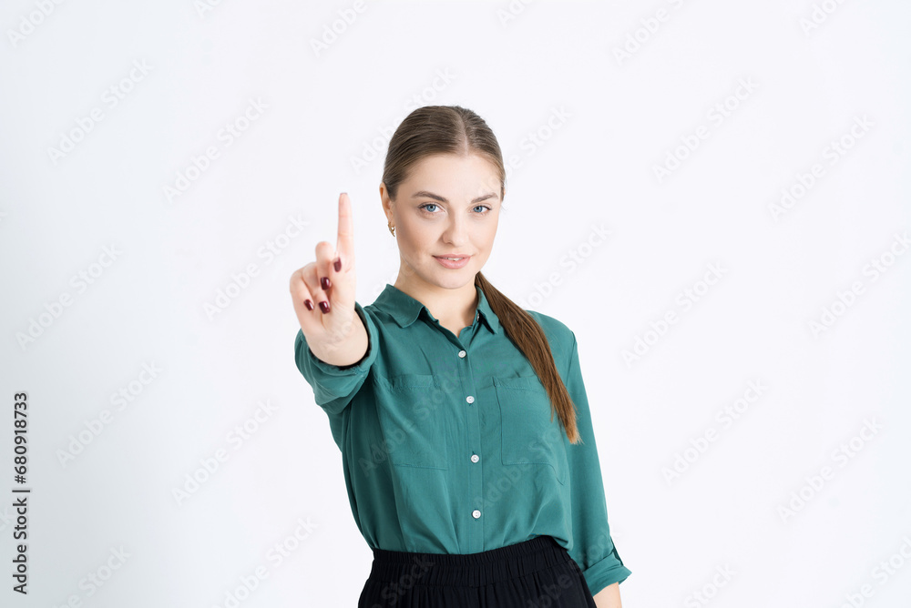 No! A young and serious woman shows a stop gesture or a taboo sign. Portrait of a businesswoman isolated on a white studio background No! A young and serious woman shows a stop gesture or a taboo sign. Portrait of a businesswoman isolated on a white studio background