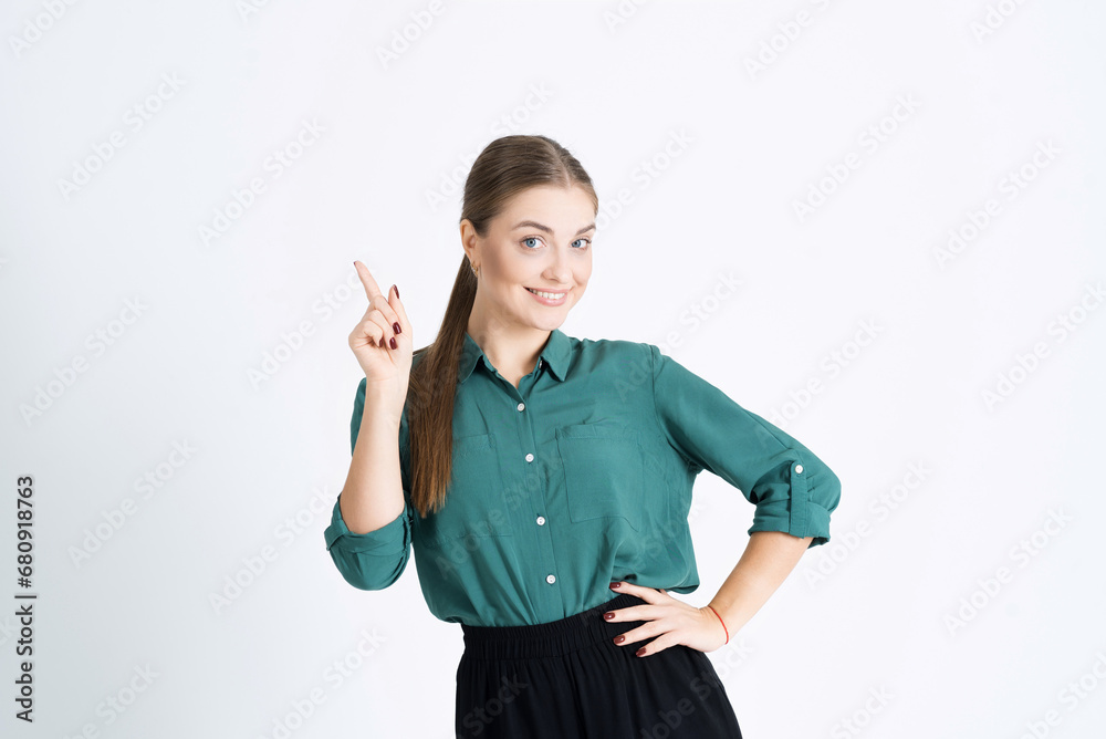 Attractive young woman gives advice, shows the number one gesture, explains the rules and makes a point isolated on a white studio background Attractive young woman gives advice, shows the number one gesture, explains the rules and makes a point isolated on a white studio background