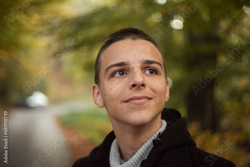 a 16-year-old teenager poses outside
