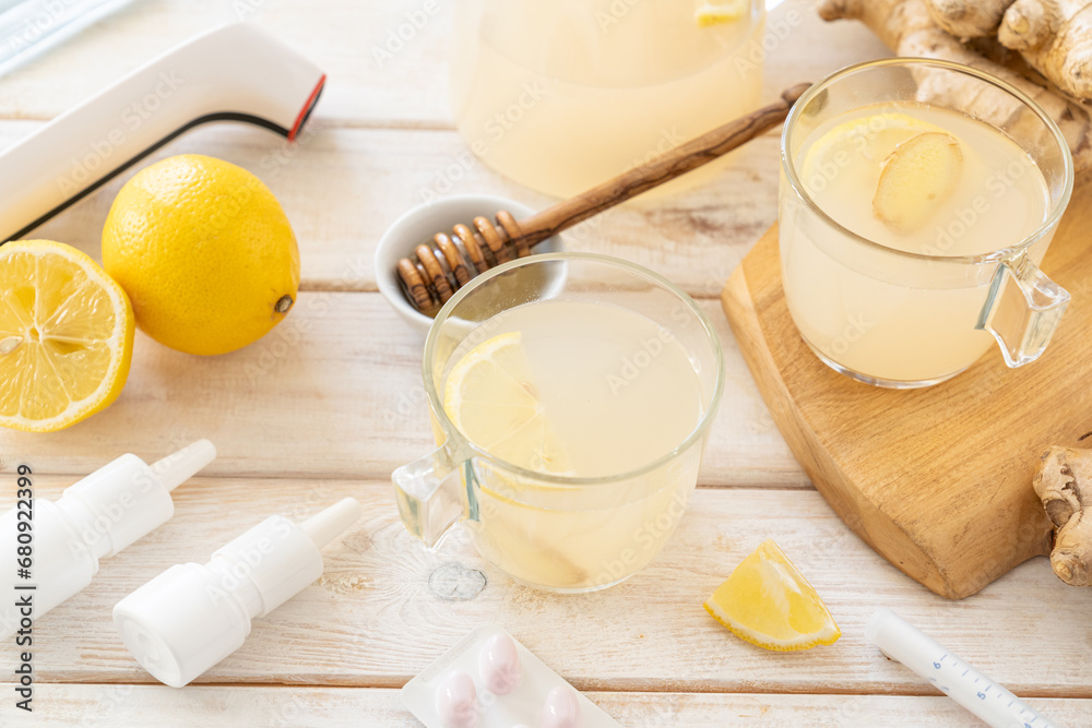 Natural cold remedies concept - ginger tea and ingredients, drugs, thermometer Natural cold remedies concept - ginger tea and ingredients, drugs, thermometer